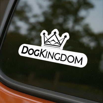 DogKingdom crown logo sticker placed on a car window with reflection of trees