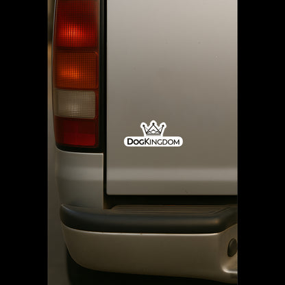DogKingdom logo sticker on the rear side of a beige vehicle near the taillight