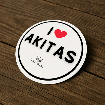 I love Akitas DogKingdom sticker placed on a wooden surface